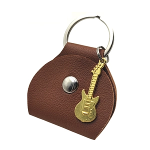 Brown leather guitar pick case keychain with a detailed golden guitar charm pendant