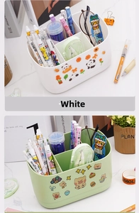 Close-up of white and green multi-grid desk organizers with cute cartoon stickers