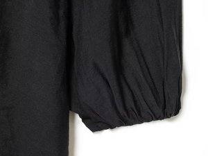 Detailed view of black lantern sleeve cuffs with pleated elastic wrist finish