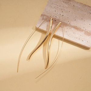 Detail of 18K gold-plated long curved earrings with high-polish minimalist sleek design