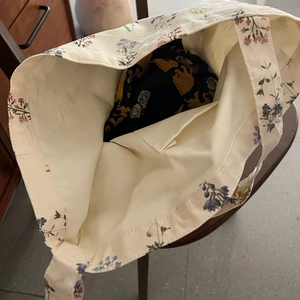 Top view of beige floral canvas tote bag showing inner pocket and spacious interior