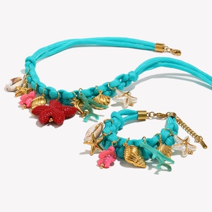 Blue woven cord necklace and bracelet set with sea shells, starfish and coral pendants