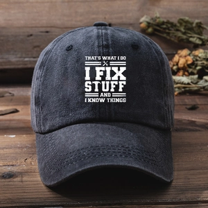 Vintage washed charcoal baseball cap with I Fix Stuff print on rustic wood background