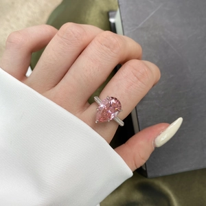 Elegant S925 silver pear cut pink gemstone ring with diamond accents worn by a model