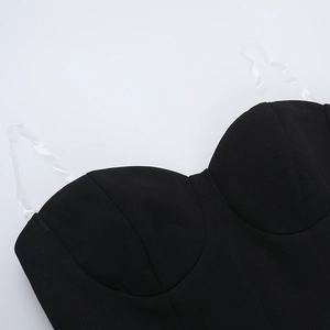 Detail of black strapless mini dress featuring transparent shoulder straps and cup design