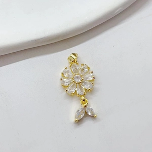 Detailed close-up of a sparkling gold daisy pendant with clear zircon flower petals