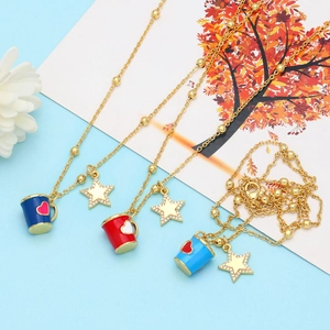 Detail of coffee cup pendants with star charms on golden bead chains for women