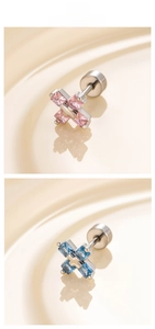 Detail of cross-shaped steel studs with pink and blue rectangular zircon crystals