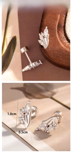 Detail view of flower-shaped titanium steel ear studs with screw back and cubic zirconia