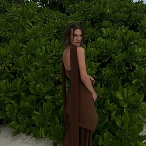 Detail of elegant dark brown backless dress with long scarf collar and slit design