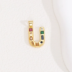 Detail view of a gold U-letter pendant featuring vibrant multi-colored baguette crystals
