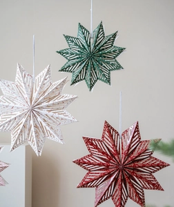 Detailed view of hollow paper star ornaments in red, green, and white for Christmas