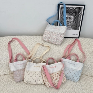 Detailed close-up of floral canvas bags featuring lace trim and vintage embroidery