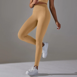 Close-up of honeycomb texture high-waisted yoga leggings in mustard yellow