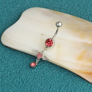 Stainless steel belly ring featuring a red crystal and pink heart pendant with wings