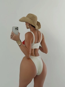 Two-piece cream white bikini set with spaghetti straps and high-cut thong design