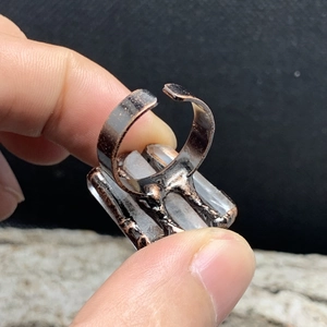 Detail of adjustable bronze ring with triple natural white crystal hexagonal pillars