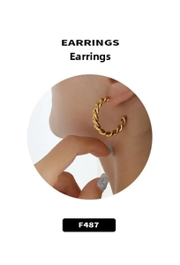 Detailed view of thick twisted rope texture on C-shaped gold hoop earrings for women