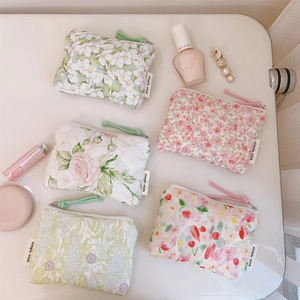 Detailed flat lay of floral cotton mini pouches with zipper closure and wristlet strap