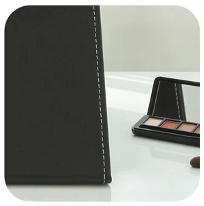 Detail of premium black PU leather case with delicate white stitching for folding mirror