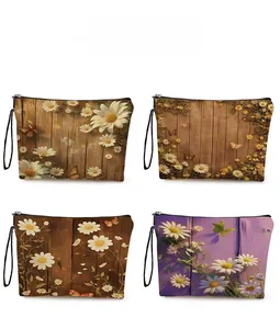 Detail showing four floral cosmetic bags with daisy and butterfly prints and zippers
