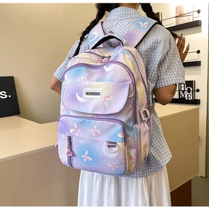 Detail of purple gradient backpack with butterfly print and functional multi-pockets