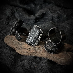 Detail of three vintage silver-plated gothic rings with dark industrial textures