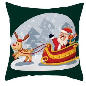 Detail of green Christmas pillow cover featuring Santa Claus on a sleigh with reindeer