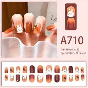 Detail of A710 press-on nails featuring cute rabbit and carrot art in orange gradient