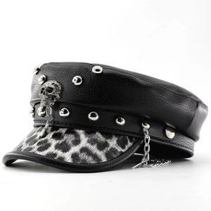 Macro detail of punk military cap featuring silver studs and skull emblem decoration