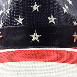 Macro shot of American flag cowboy hat with star studs and woven stripe texture