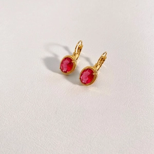 Close-up of vintage oval red ruby pendant earrings with gold-plated stainless steel hooks