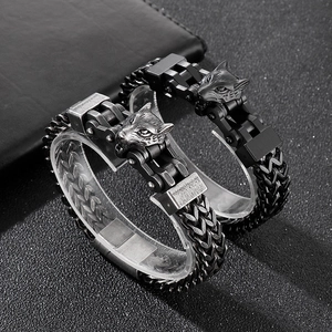 Close-up of hip-hop punk wolf head clasp on vintage silver and matte black steel bracelets