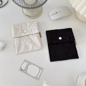 Close-up of seersucker floral pouches with snap button for organizing small essentials