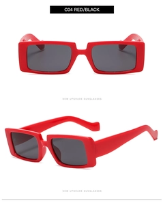 Detail shot of vintage red rectangular sunglasses with dark lenses and a glossy frame finish