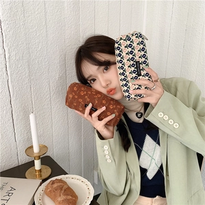 Detail of vintage corduroy pencil cases with floral and geometric patterns in hands