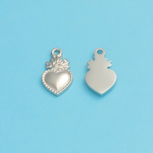 Macro view of silver stainless steel sacred heart charms with flame detail and smooth back