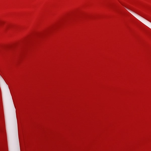 Vue macro détaillée de la texture du tricot rouge et des coutures de la robe à manches longues
