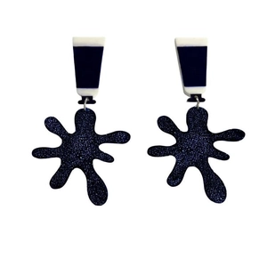 Detail of glittery dark blue acrylic paint splatter earrings with star shapes