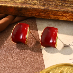 Detail view of red enamel geometric square earrings with gold plating in vintage style