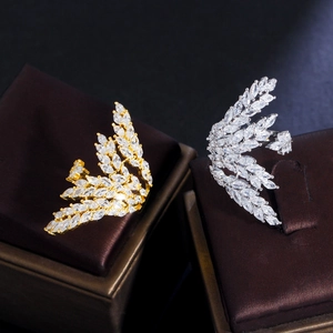 Macro shot of gold and silver angel wing rings with sparkling marquise cut cubic zirconia