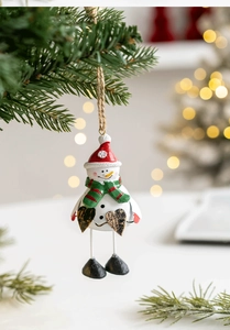 Detailed view of resin snowman Christmas ornament hanging on a festive tree with warm lights