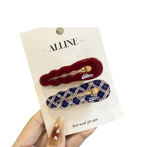 Set of two vintage hair clips featuring wavy wine red and navy checkered patterns