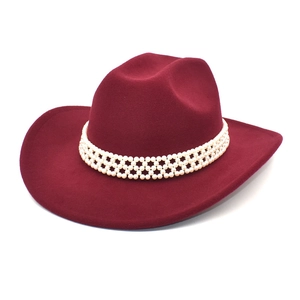 Close-up of wine red wool cowboy hat featuring triple-row pearl beaded trim detail