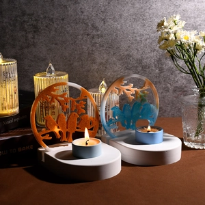 Creative bird silhouette candle holder in vibrant orange and blue resin with warm lighting