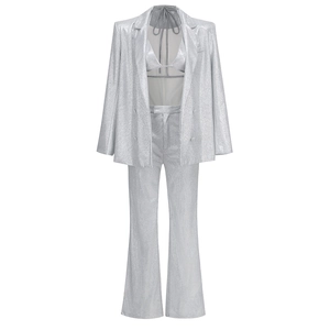 Close-up of sparkling silver sequin three-piece suit with blazer, bra top and trousers