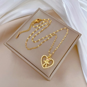 Elegant gold titanium heart pendant necklace with crystal teddy bear on silk base
