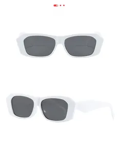Detail of white polygon sunglasses with thick temples and dark gray lenses