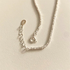 Detailed view of S925 sterling silver chain with unique crushed silver texture and clasp