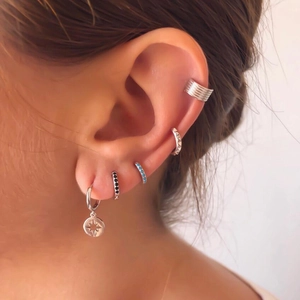 Classic silver hoop earrings and ear cuffs with zircon pendants on model ear